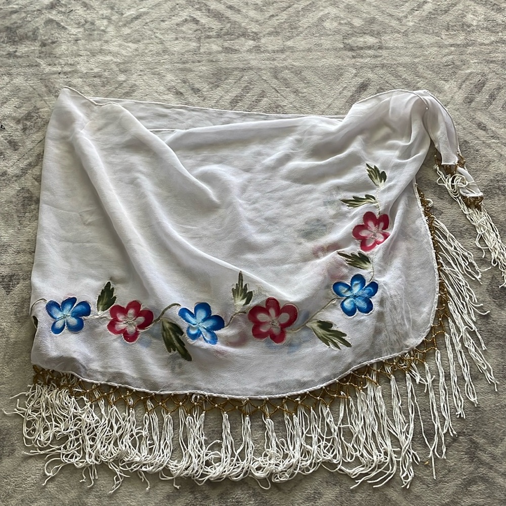 Swim suit cover with tassels, gold beads and floral design and a tie on the side